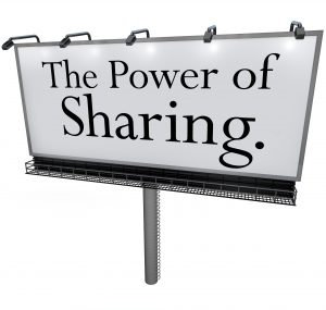 The words Power of Sharing on a white billboard, banner or outdoor sign to encourage you to give, share, donate or volunteer to help provide relief or assistance others in need